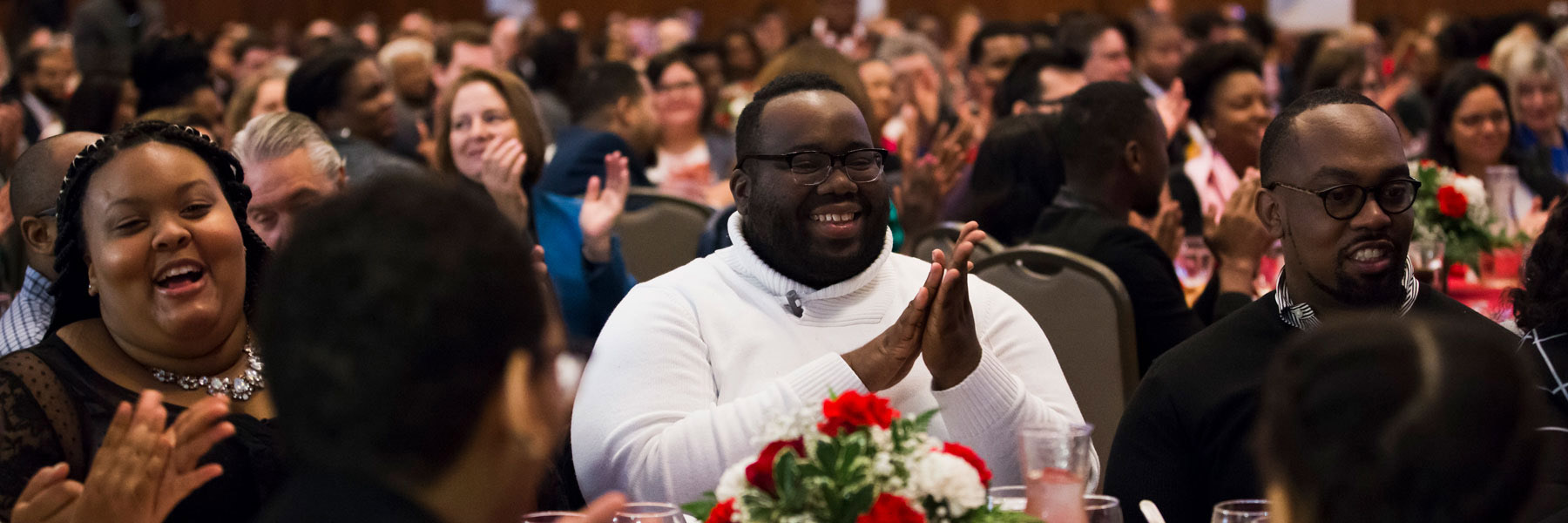 Sitting attendees clap during MLK Celebration.